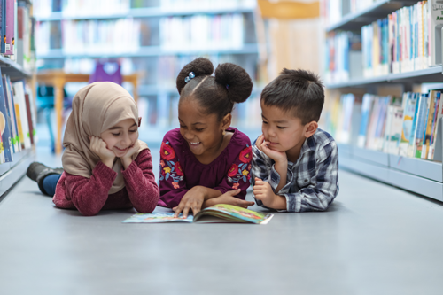 small children reading in a library