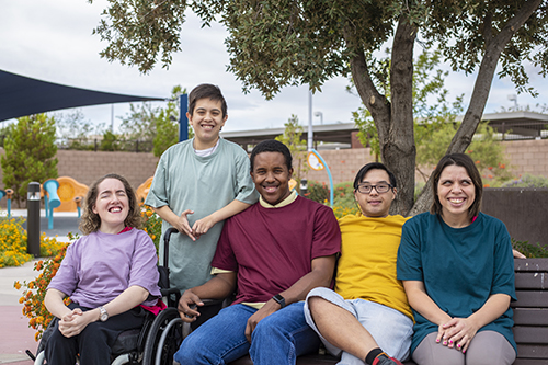 young adults at a public park pose for a picture